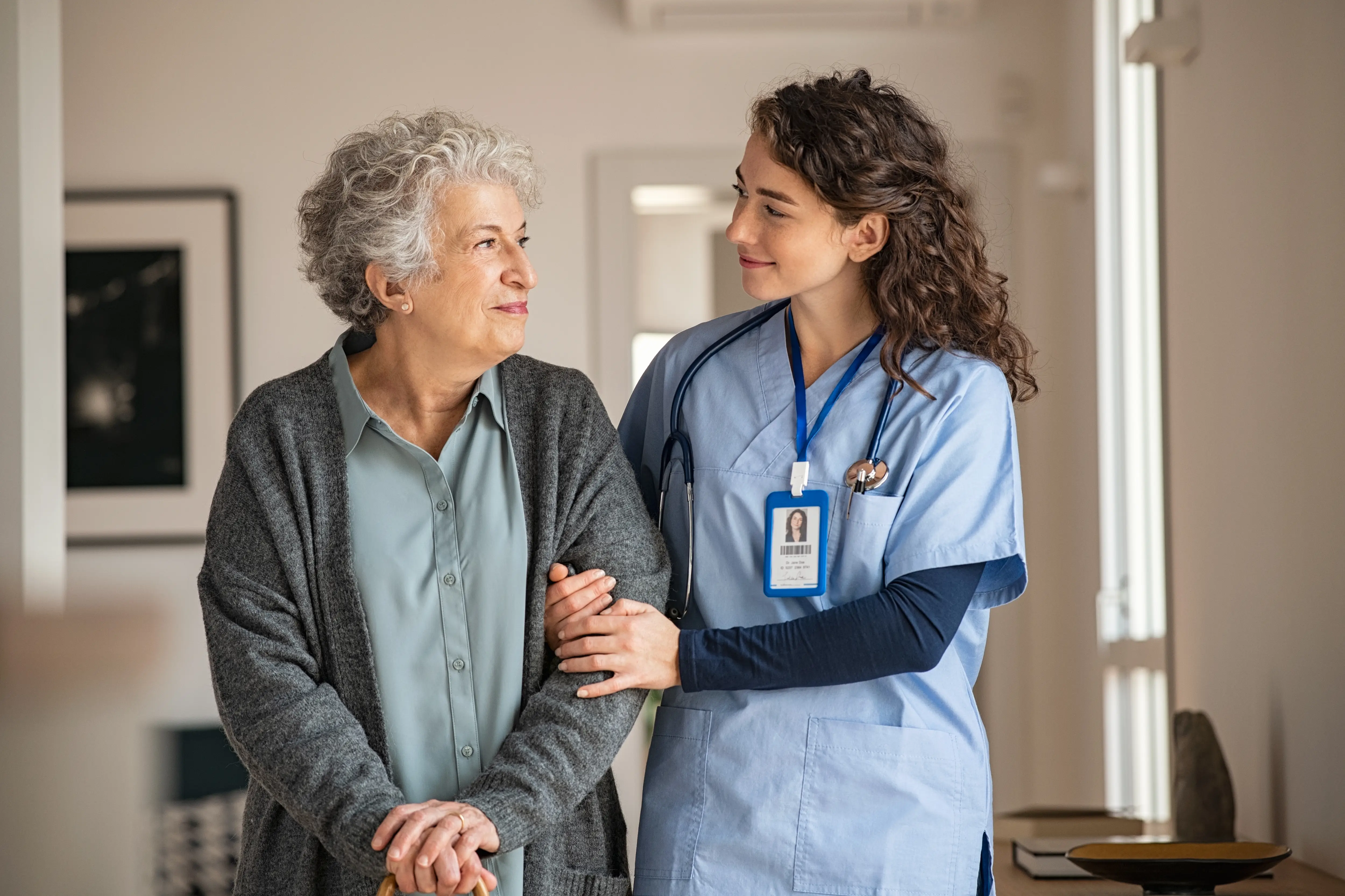 Nurse and old woman walking