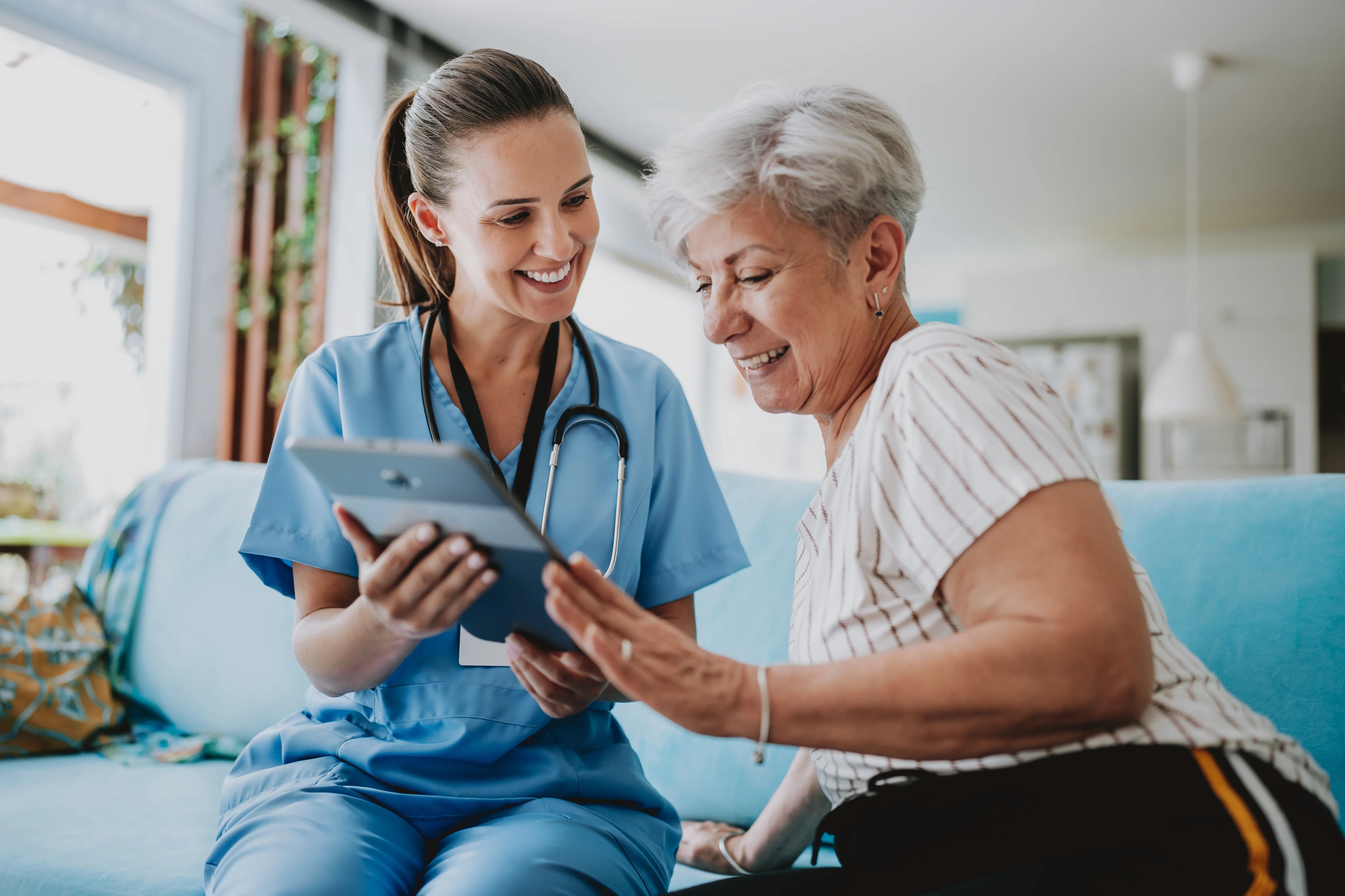 Nurse with elderly woman with iPad